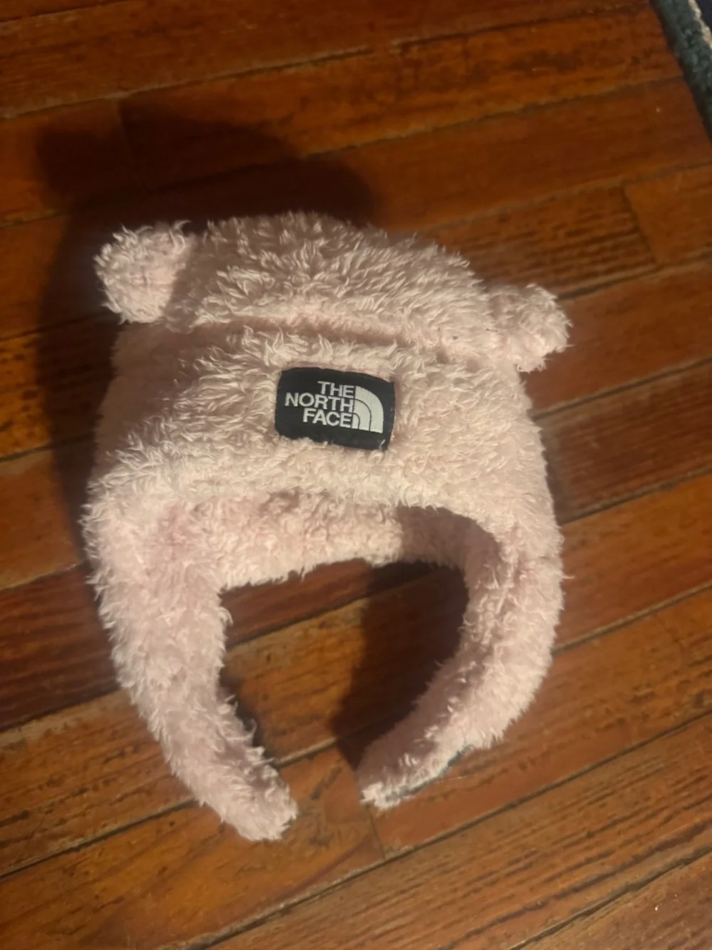 North Face Baby Bear Suave Oso Beanie in pink with a prominently displayed woven